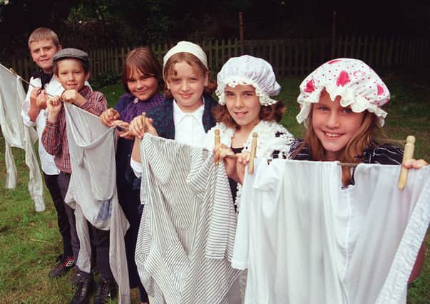 Children from the Emmanuel Junior school, Waterthorpe are seen hanging out the washing during their visit to the hamlet in 1999