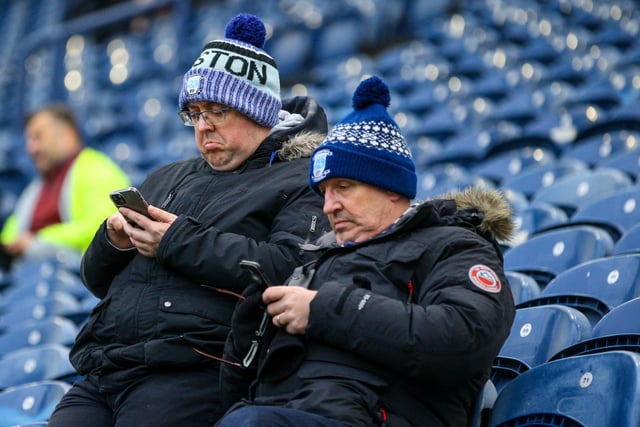 Two PNE fans check the team news on their phones