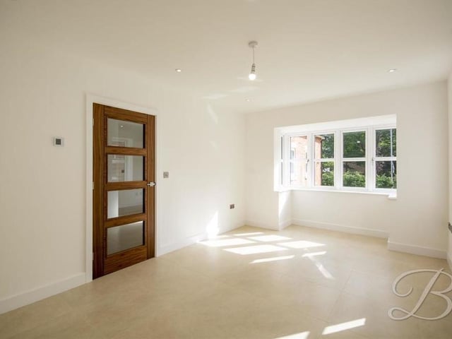 Moving into the living room or snug, this is a lovely space with windows to the side and down lights.