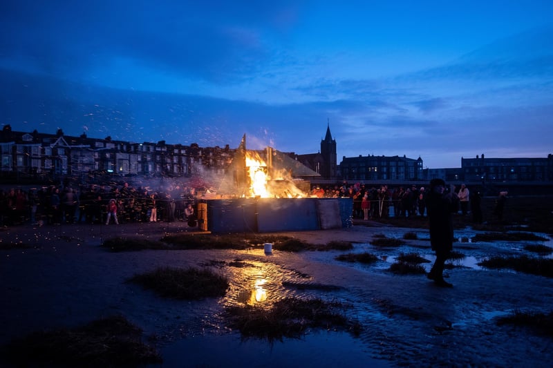 The boat well alight at the More Music memorial event on Morecambe beach to mark 20 years since the cockling tragedy.