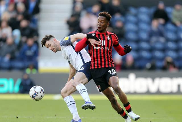 Preston North End defender Andrew Hughes challenges Bournemouth's Jamal Lowe