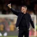 PNE boss Ryan Lowe salutes the fans after the Wolves game.