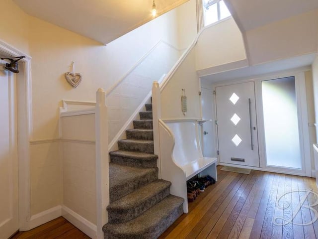 It's time to head upstairs now, which means going back into this splendid hallway, which contains two storage cupboards