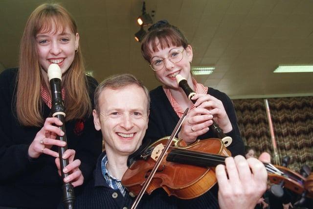Halle Orchestra violinist Mike Hall with Tulketh High School pupils Gemma Campbell and Karen Heywood during a music workshop at the Preston school in 1998
