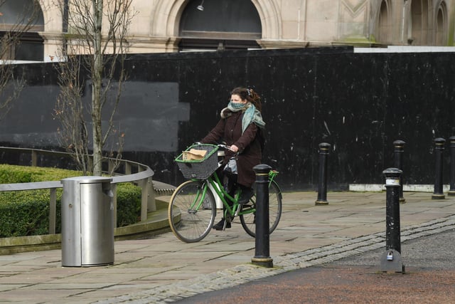 Exercising was permitted during the lockdown and this cyclist was taking no chances - keeping her face covered with a scarf