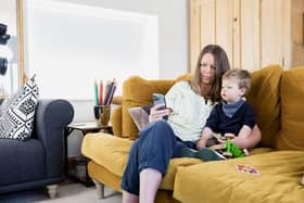Woman with toddler looking at smartphone - copyright SafeKeep