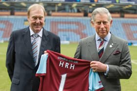 Then Prince Charles poses with Burnley Chairman Barry Kilby (L) while holding a Burnley football shirt as meets representatives of Burnley Football Club at Turf Moor, the Burnley football club ground on February 5, 2010 in Burnley, England.  (Photo by Arthur Edwards/WPA Pool/Getty Images)