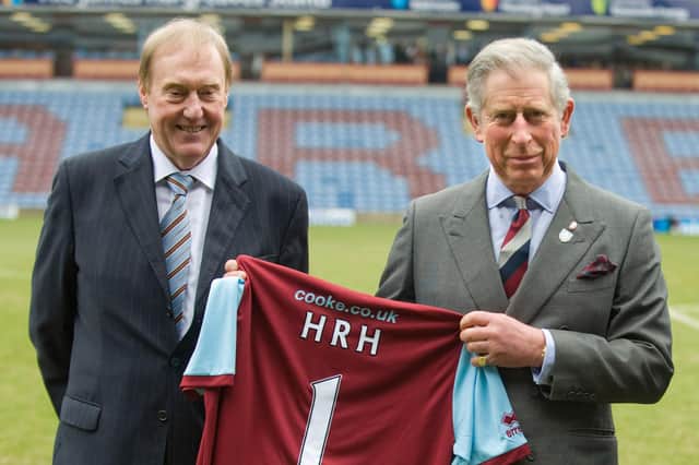 Then Prince Charles poses with Burnley Chairman Barry Kilby (L) while holding a Burnley football shirt as meets representatives of Burnley Football Club at Turf Moor, the Burnley football club ground on February 5, 2010 in Burnley, England. (Photo by Arthur Edwards/WPA Pool/Getty Images)