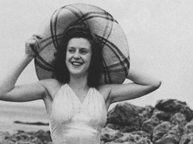 Lydia Reid, winner of the first final in 1945, poses in the white satin swimsuit made specially for the contest by her mother.