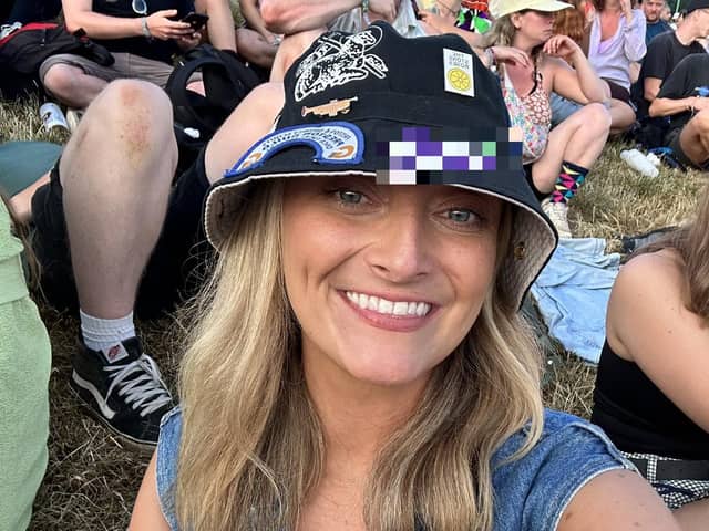Kirsty Manley at Glastonbury wearing the PNE hat she found. She now hopes to reunite the hat with its owner