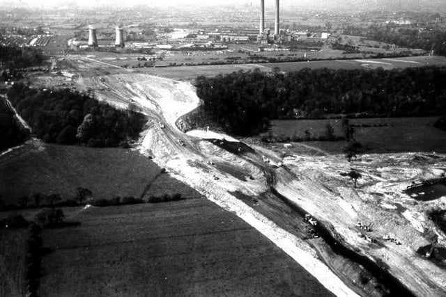 Aerial view of the excavations taking place on the north escarpment. The factory in the background is the Courtauld's Red Scar works. The first section of the motorway, and the first motorway in the country, the Preston by-pass, was built by Tarmac Construction and opened by the then Prime Minister Harold Macmillan on 5 December 1958. Picture courtesy of Preston Digital Archive