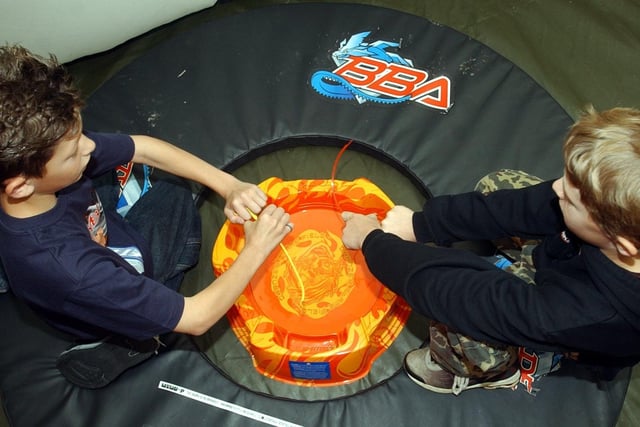 Craig Campbell, 10 (left) and Daniel Kennedy, 11, prepare to battle at the Bey-blades Championship at Toys R Us, Preston in 2003