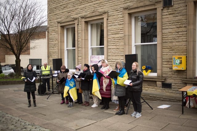 A group of singers perform outside the town hall