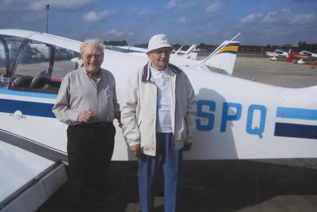 FILE PHOTO - Ernie (L) with a French plane designer in 1980.