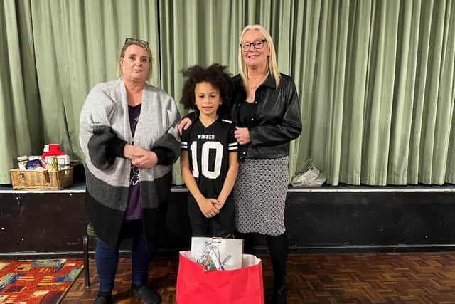 Joan Musker and Andrea Andrews with Taylor who received a gift bag last year. Photo:  Progress Housing Group