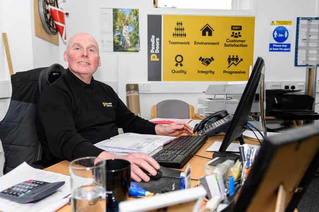 Buyer Ian Holdfield at his desk at Pendle Doors in Darwen. Photo: Kelvin Stuttard