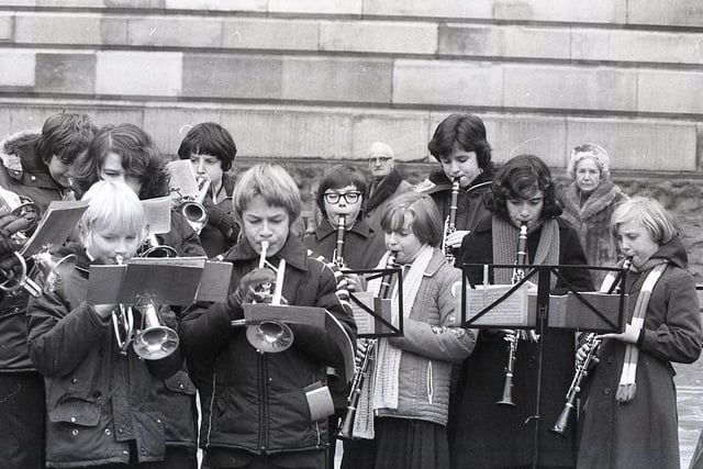 Providing a Christmas treat for the passing throngs of shoppers requires a great deal of concentration, as well as huff and puff - as this pictures shows during Tulketh High School Band's 1978 carol outing to Preston Flag Market