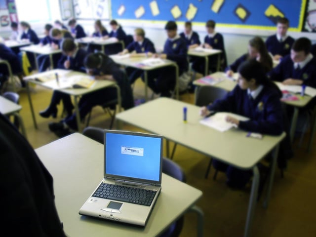 Ribbleton Hall High School head teacher Steve Roe with one of the laptops which were taking over from the traditional registration books in 2002