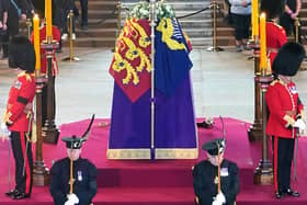 Britain's Scotland Secretary Alister Jack (front left) and Defence Secretary Ben Wallace (front right), in their roles as members of the Royal Company of Archers, stand with Grenadier Guards guarding the coffin of Queen Elizabeth II as it Lies in State inside Westminster Hall, at the Palace of Westminster in London on September 15, 2022