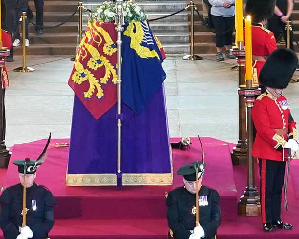 Britain's Scotland Secretary Alister Jack (front left) and Defence Secretary Ben Wallace (front right), in their roles as members of the Royal Company of Archers, stand with Grenadier Guards guarding the coffin of Queen Elizabeth II as it Lies in State inside Westminster Hall, at the Palace of Westminster in London on September 15, 2022