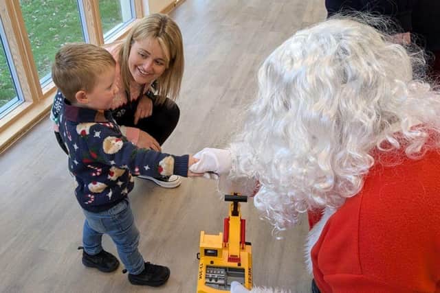 Registered Care Manager Katie Pennington with her son meeting Father Christmas at the event