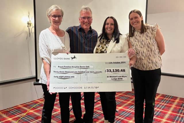 John Holmes and his wife Catherine, far left, present a cheque to Maria Roach from RPH Burns Unit, second right, and Lucy Clark of Lancashire Teaching Hospitals Charity.
