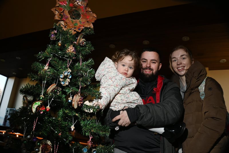 Martin Meadows, Chloe Croft and one-year-old Elodie admire the trees.