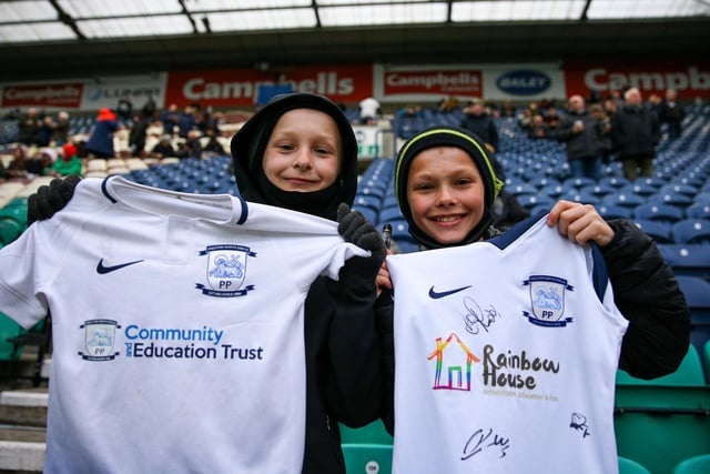 Two youngsters in the Town End with their signed PNE shirts