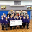 Cheque for £5,000 being presented to pupils at the school