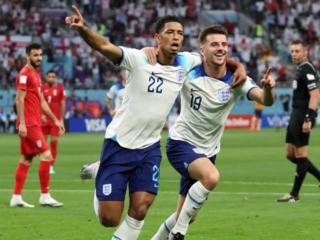 England's Jude Bellingham (left) celebrates opening the scoring against Iran with Mason Mount Picture: Clive Brunskill/Getty Images)