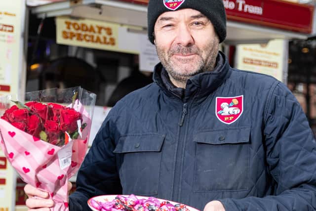 Tony Nelson, owner of the Hot Potato Tram in Preston which has moved to the front of the market on Tuesdays and Thursdays with flowers and lovebug sweets which he is giving to customers for Valentine's Day