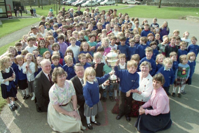 A school near Carnforth has scooped a road safety award, beating off competition from the rest of the county. The magnificent trophy, donated to the county council by the RAC in 1985, was awarded to Warton Archbishop Hutton Primary School by deputy county road safety organiser Mr Ken Ashby. Pupils Carly Boak, six, and Matthew Wetherill, five, received the trophy watched by fellow pupils