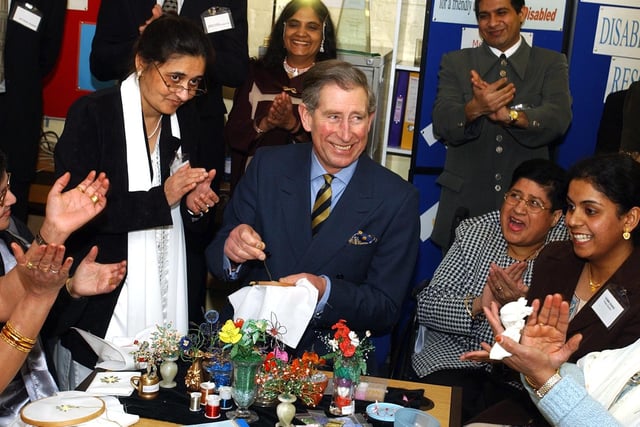 Prince Charles tries his hand at Lazy Daisy Embroidery during his visit to the Pukar Centre in Preston