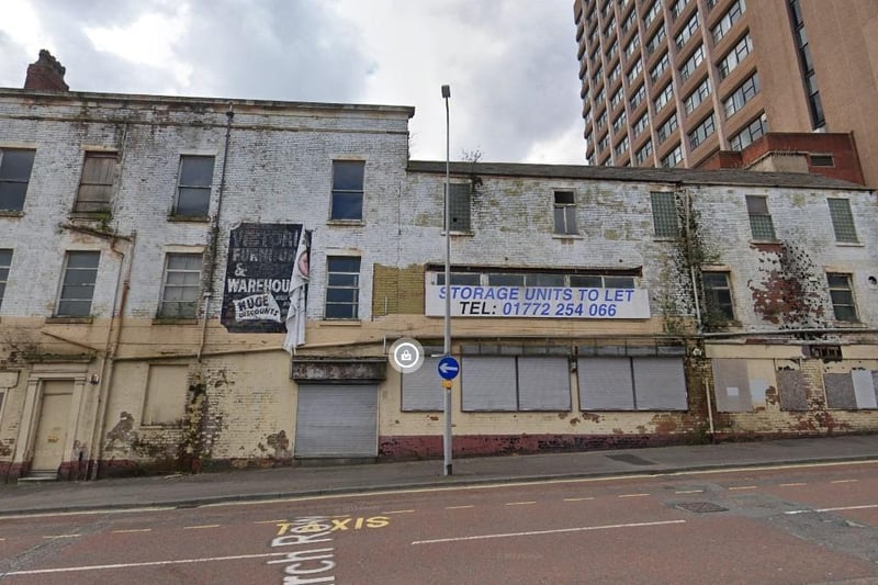 Victoria Furniture & Carpet Warehouse: Still displaying the classic but fading old sign on the side of a building which reads Victoria Furniture & Carpet Warehouse, this building has been boarded up for a while, with the paint also flaking heavily.