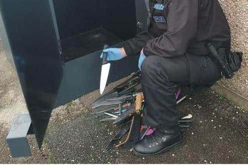 Police emptying a knife bin last year.
