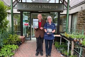 Wray historian David Kenyon with nurse Sarah Gorst at St John's Hospice. David and Sarah are pictured with the front covers of the local history book David has written, the proceeds of which are being donated to the hospice.