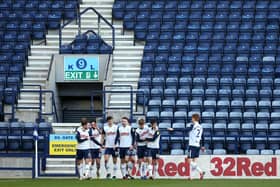 PRESTON, ENGLAND - FEBRUARY 27: Ched Evans of Preston North End celebrates with his team mates in front of empty seats after scoring his team's second goal during the Sky Bet Championship match between Preston North End and Huddersfield Town at Deepdale on February 27, 2021 in Preston, England. Sporting stadiums around the UK remain under strict restrictions due to the Coronavirus Pandemic as Government social distancing laws prohibit fans inside venues resulting in games being played behind closed doors. (Photo by Charlotte Tattersall/Getty Images)