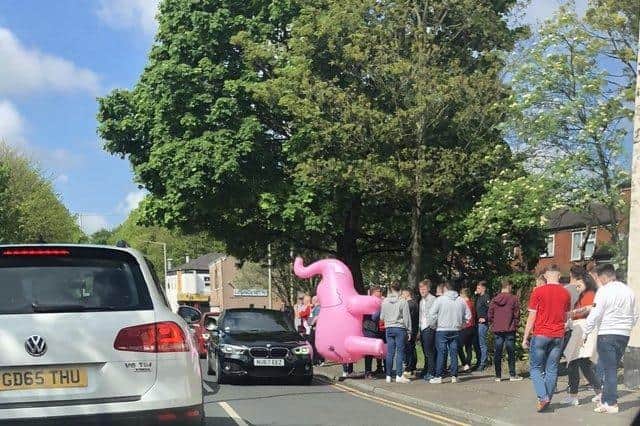 Visiting Middlesbrough fans and their giant inflatable pink elephant after catching a lift to the pub from police in Preston. Credit: @evertonianfenny