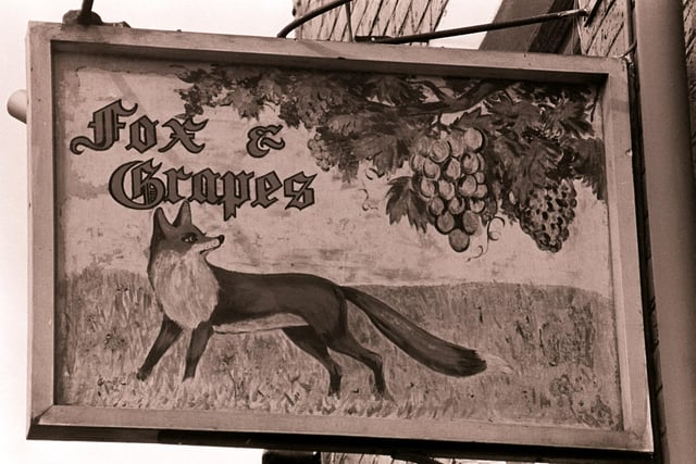 The name Fox and Grapes probably refers to one of Aesop's Fables. The story concerns a fox that tries to eat grapes from a vine but cannot reach them. Rather than admit defeat, he states they are undesirable. That story can be seen here in the sign that used to hang outside the boozer. The name was likely given to this particular pub due to the name of the street it was located on - Fox Street in Preston