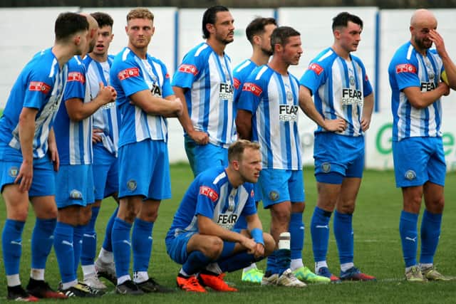 Players look on anxiously during the penalty shootout which Lancaster lost to City of Liverpool in the FA Trophy  Photo: JOSHUA BRANDWOOD