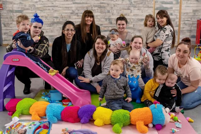 Community Network and Outreach Service CIC Parent and Toddler Group has received funding with a Redrow community grant: Redrow's Pam Roberts, fourth from left, and founder and chair Sophie Wilding, third from left, with group members.