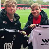Champion fund raisers Freddie Xavi (left) and Hughie Higginson with their Salford FC t shirts. A fundraising appeal to improve play facilities for poorly children from across the North West, fronted by  the best pal has hit the halfway point after just two months.