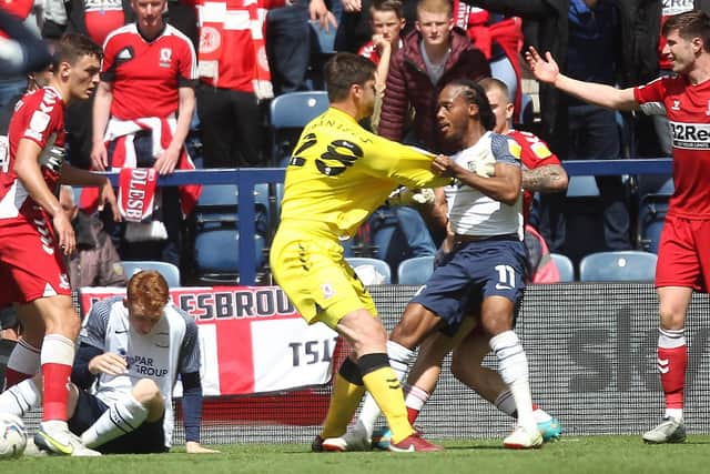 Preston North End's Daniel Johnson grapples with Middlesbrough keeper Luke Daniels as tempers flare at Deepdale