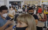 Travellers queue at Manchester Airport