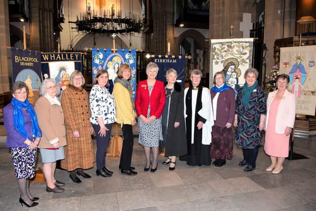 New Mothers’ Union president Gill Ireland pictured (centre) with newly commissioned office holders and Mothers’ Union members in front of Mothers’ Union banners from around the Diocese, after the service at Blackburn Cathedral