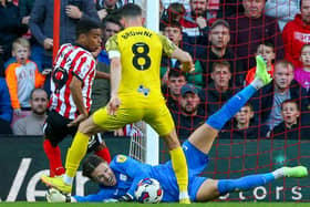 Preston North End's Freddie Woodman saves at the feet of Jewison Bennette.