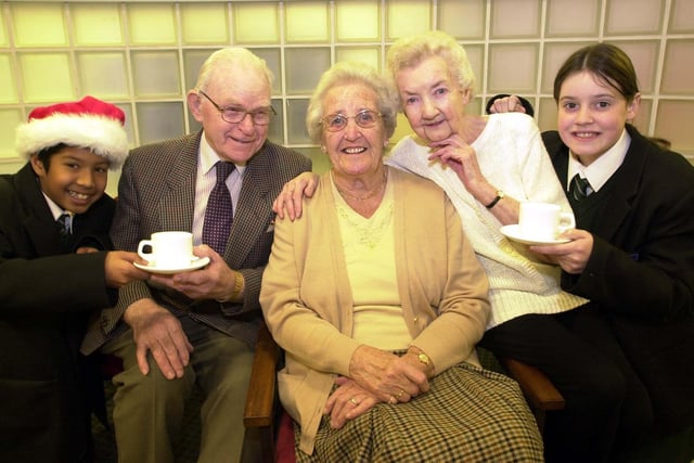 Fulwood High School year 7 pupils, from left, Jason Seetal, 12, and Jenni Hanley, 12, with Thomas Taylor, Kath Proctor and Norah Heys, during the old folks party at the school