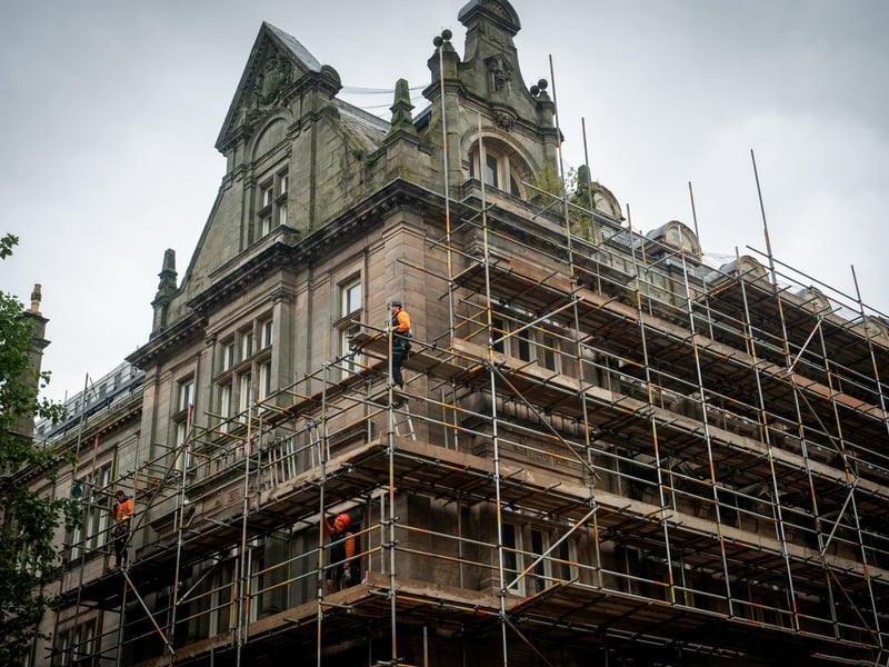 Workmen erecting scaffolding on the former Post Office building in Preston City Centre