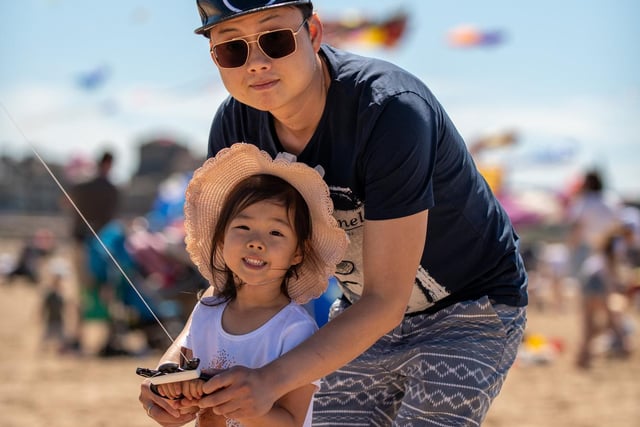 Catch the Wind kite festival in Morecambe - Pictured - Enjoying the Kite Festival: Dawn Lie Age 4 With Dad Zhimin Lei 10.07.2022. Picture by Anthony Farran.