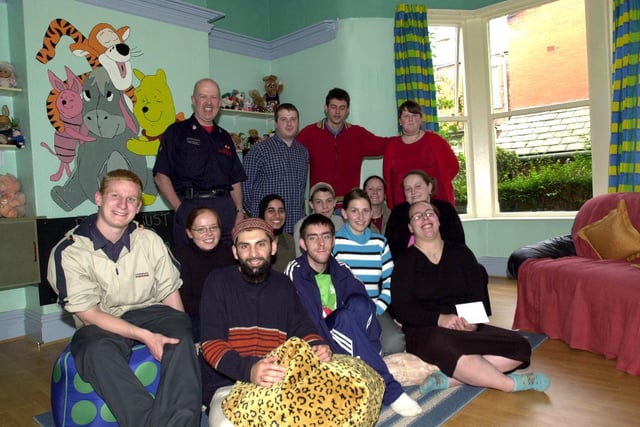 Prince's Trust Team 18 volunteers with representatives of Lancashire Firefighters in the family room at Preston's Women's Refuge which they have renovated